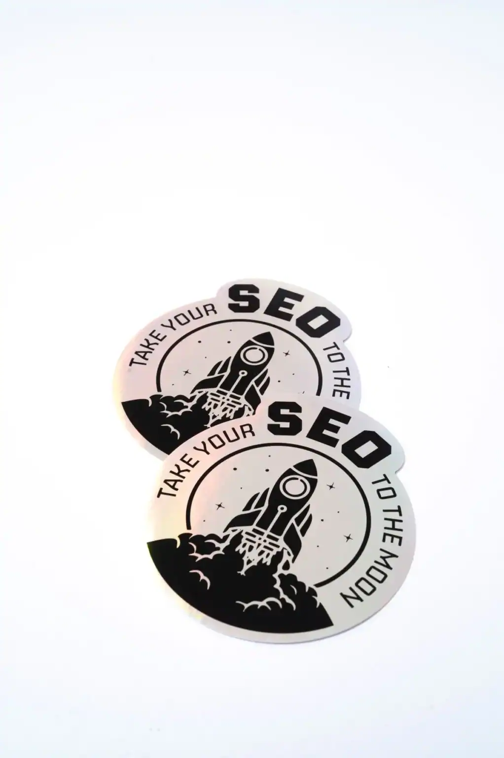 Take your SEO to the moon sticker, featuring a rocket launch design for SEO enthusiasts and digital marketers. Perfect for laptops, notebooks, or marketing campaigns.