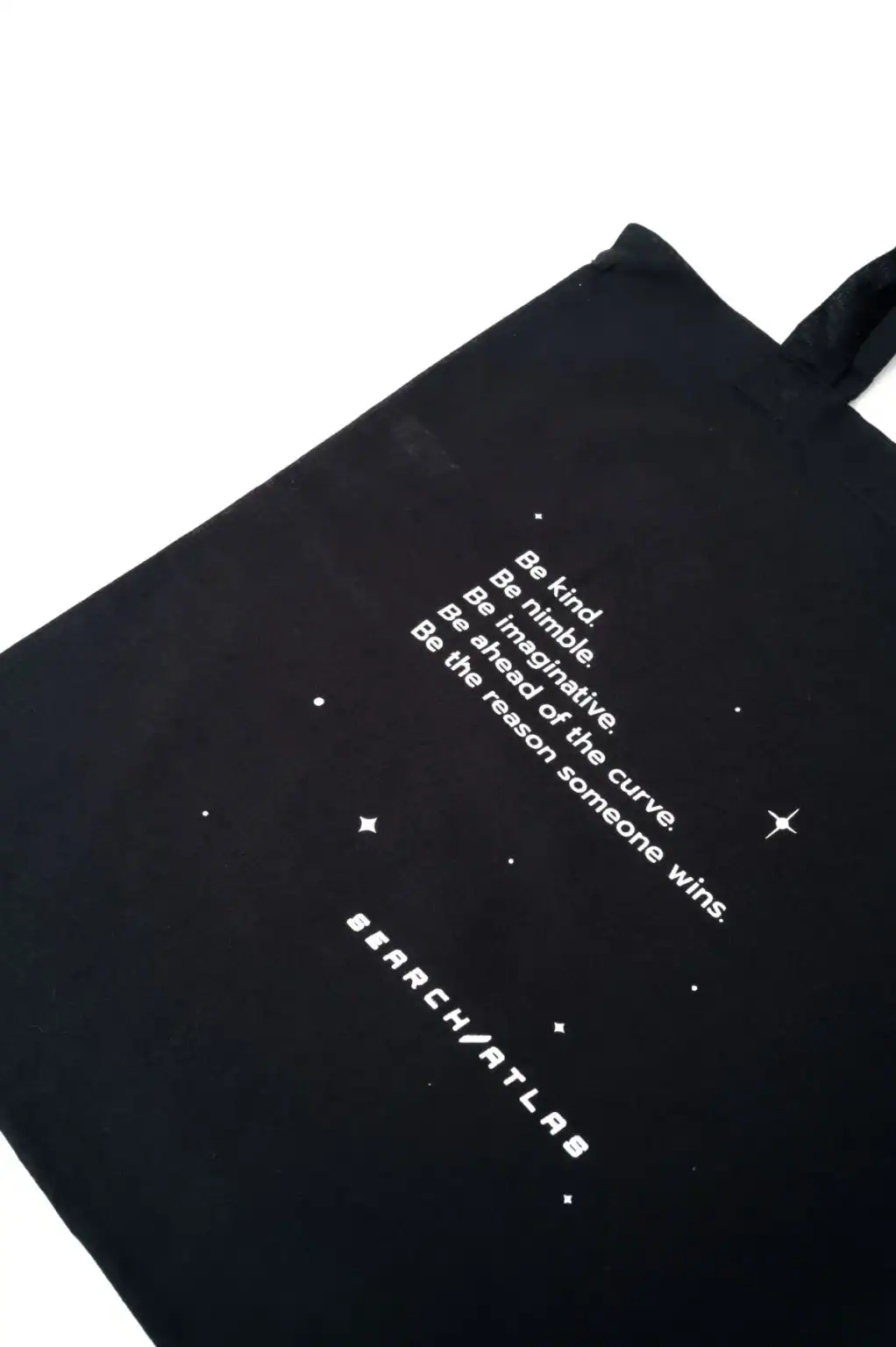 Search Atlas store tote bag with inspirational space-themed quote and stars design promoting positivity and mindfulness.