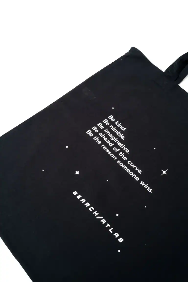 Search Atlas store tote bag with inspirational space-themed quote and stars design promoting positivity and mindfulness.