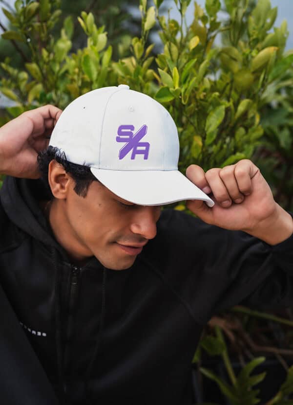 Stylish white baseball cap with purple Search Atlas logo, perfect for outdoor activities and casual wear, featuring adjustable fit and durable fabric.
