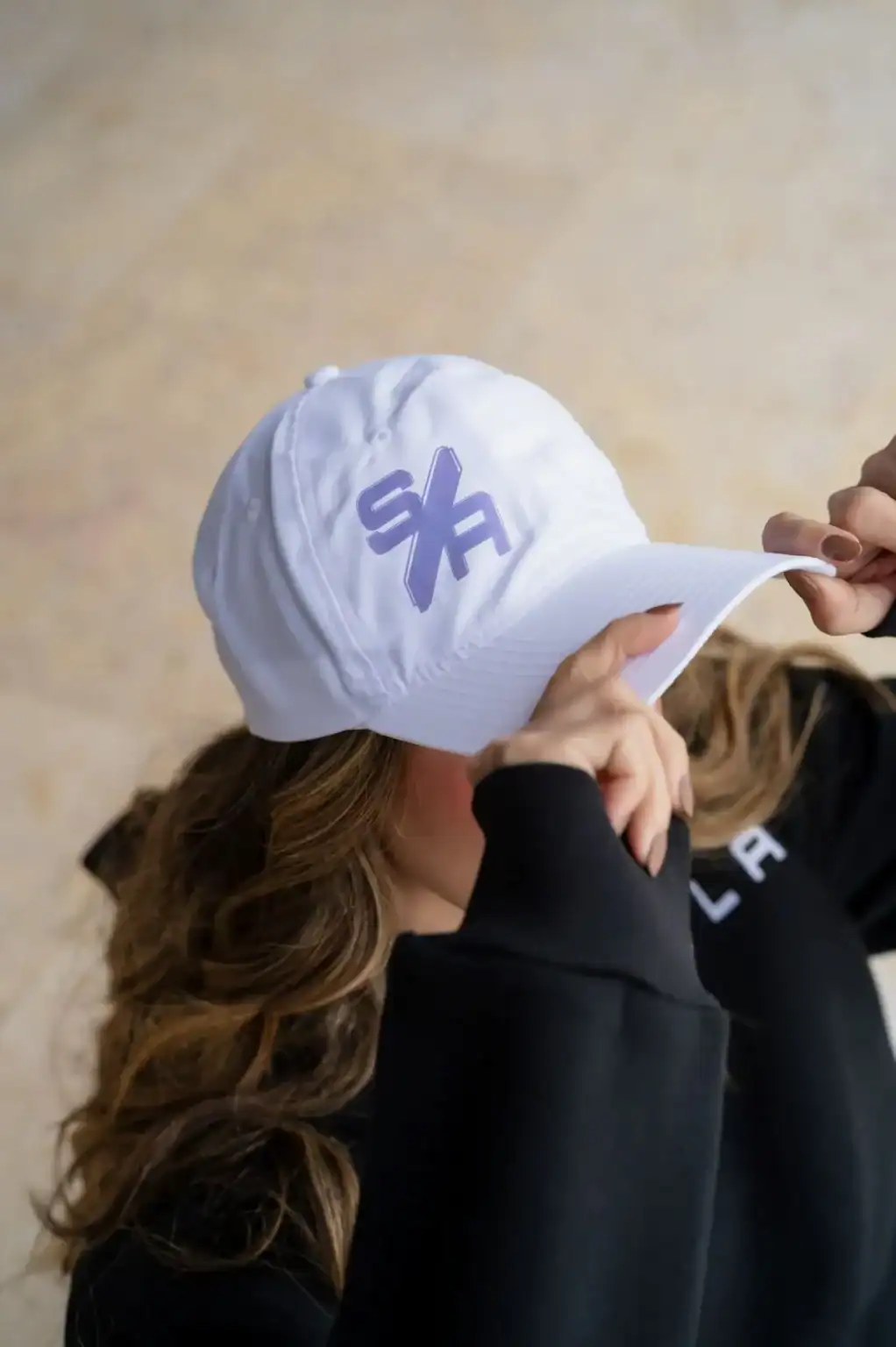 White baseball cap with purple logo, casual streetwear accessories, stylish headwear for women and men, trendy sportswear cap, fashionable headgear for outdoor activities, Search Atlas Store merchandise.
