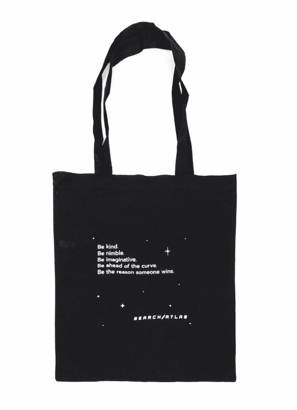 Black tote bag featuring inspirational message: "Be kind, be nimble, be imaginative, be ahead of the curve, be the reason someone wins" from Search Atlas store, perfect for daily use and promoting positivity.