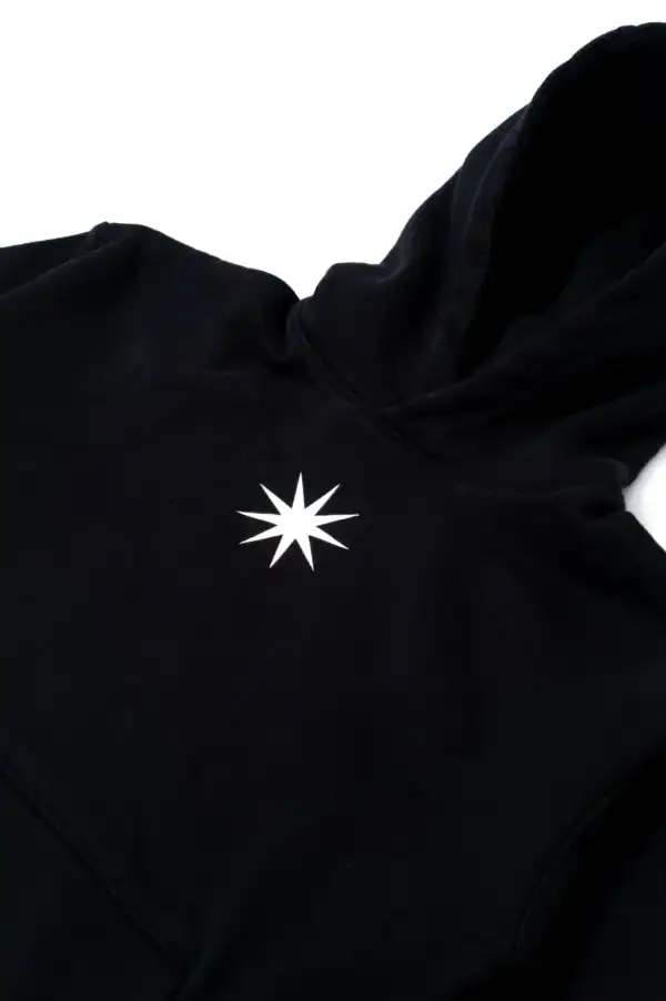 Minimalist black hoodie with white starburst logo, perfect for stylish casual wear and street fashion. Comfortable, trendy, and ideal for everyday use.