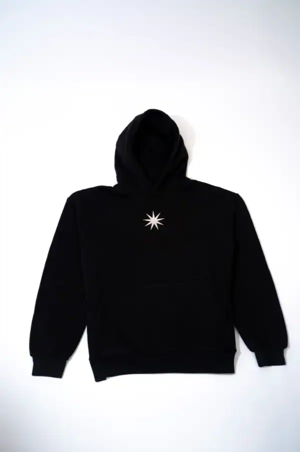 Black hoodie with a starburst design on the chest, perfect for streetwear fashion and casual styling. Features a front pocket and adjustable hood for comfort and versatility. Ideal for everyday wear.