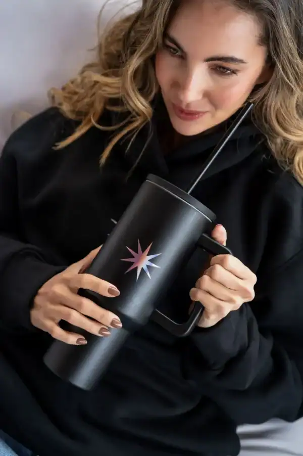 Search atlas store black tumbler with star logo, reusable steel drinkware, modern coffee mug for travel, stylish black insulated tumbler with straw, premium drink container for hot or cold beverages.
