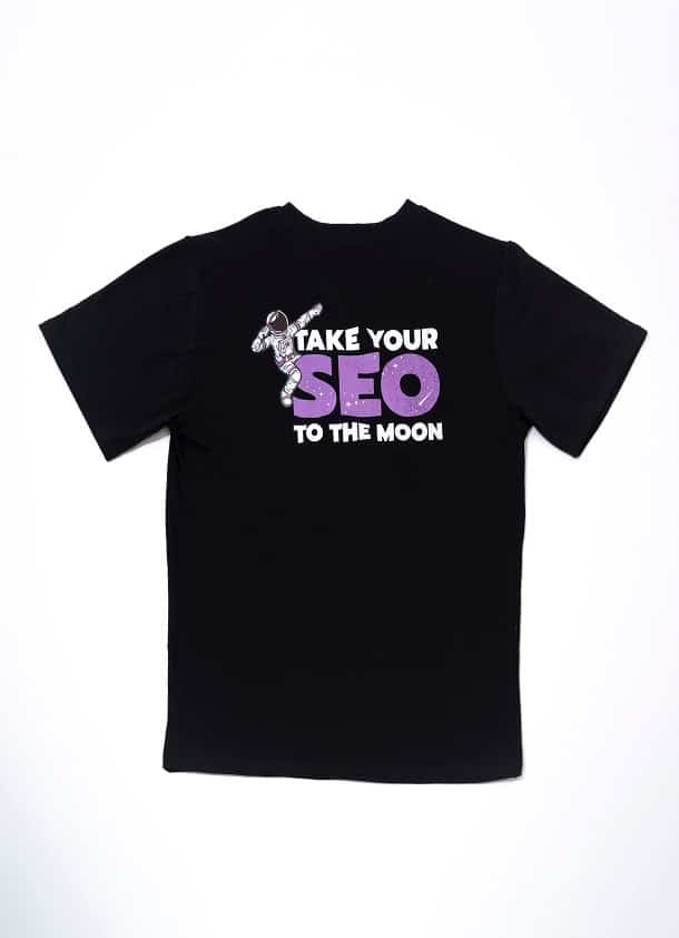 Stylish black SEO-themed t-shirt featuring a fun astronaut graphic and text "Take Your SEO to the Moon", perfect for digital marketing enthusiasts.