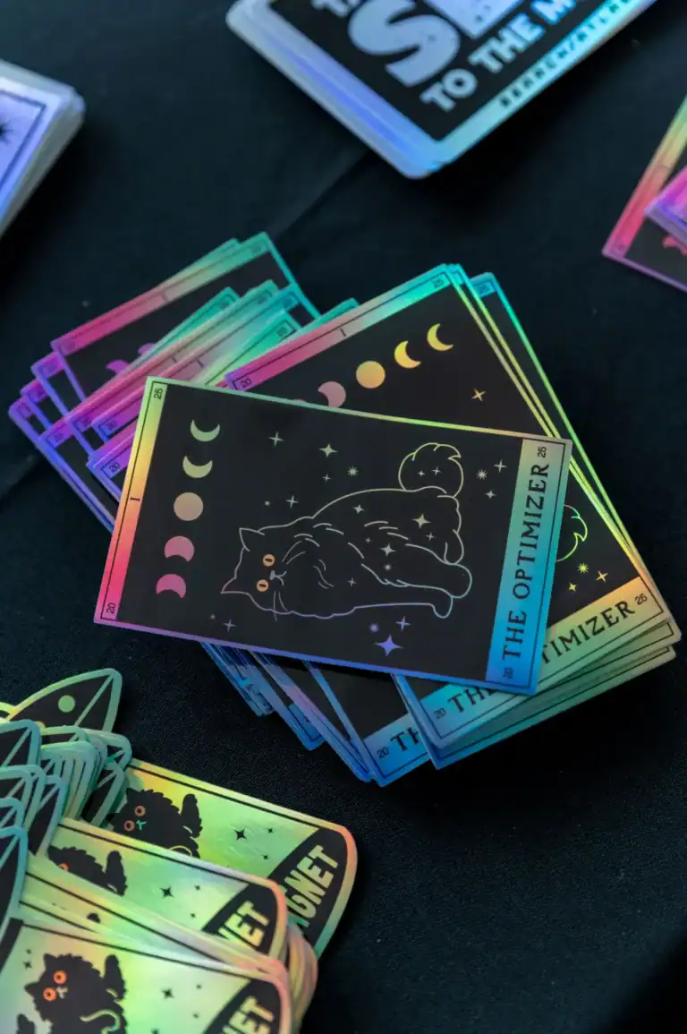 Colorful holographic tarot card stickers featuring a black cat, moon phases, and starry night designs, perfect for astrology, mystical decor, or spiritual journal embellishments.