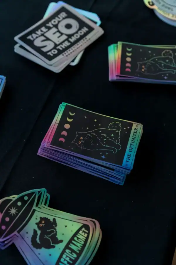 Colorful astrology-themed sticker cards featuring black cats, moons, stars, and space elements, displayed on a dark surface for cosplay, decoration, or collectable purposes.