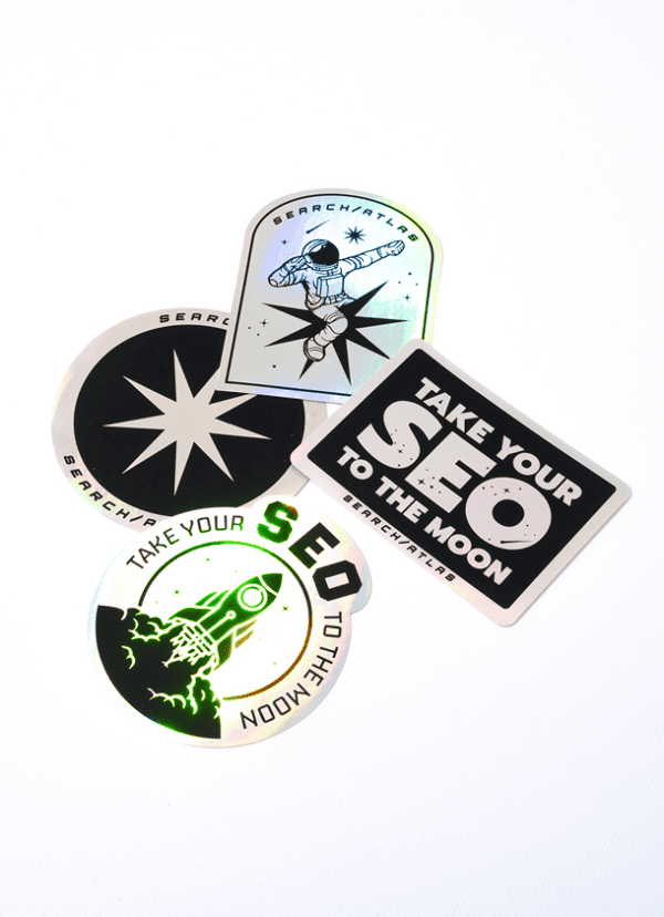 Colorful SearchAtlas stickers featuring space-themed designs and motivational slogans. Perfect for branding, marketing, or personalizing tech gadgets with SEO and digital marketing focus.