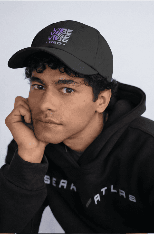Fashionable black cap with "Vibe" and "SEO" embroidered in vibrant colors, perfect for streetwear and casual outfits.